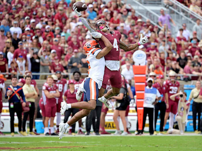 Oct 14, 2023; Tallahassee, Florida, USA; Florida State Seminoles wide receiver Keon Coleman (4) catches a pass over Syracuse Orange defensive back Jason Simmons Jr. (6) during the first quarter at Doak S. Campbell Stadium. Mandatory Credit: Melina Myers-USA TODAY Sports